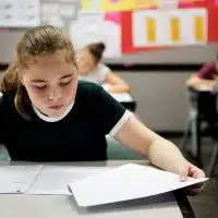 Students doing exam in classroom