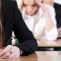 Students writing an exam at university, horizontal